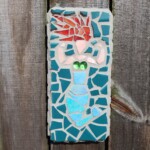Mermaid Sister Three A mermaid mosaic made with ceramic tile, colored glass, and glass beads. Fair skin, red hair, blue torso